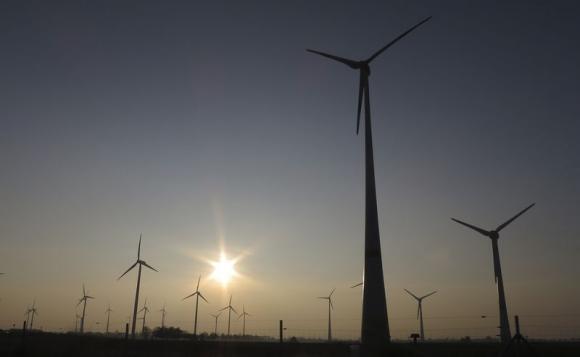 The sun sets behind power-generating wind turbines from a wind farm near the village of Ludwigsburg